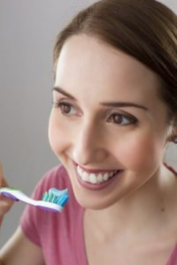 a lady brushing her teeth